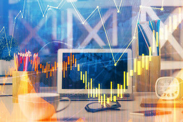 Double exposure of graph and financial info and work space with computer background. Concept of international online trading.