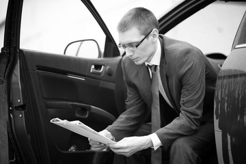 Businessman in a suit  in a car