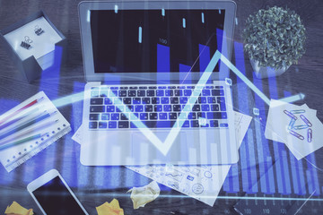 Financial graph colorful drawing and table with computer on background. Multi exposure. Concept of...