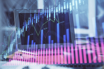 Stock market graph and table with computer background. Double exposure. Concept of financial analysis.