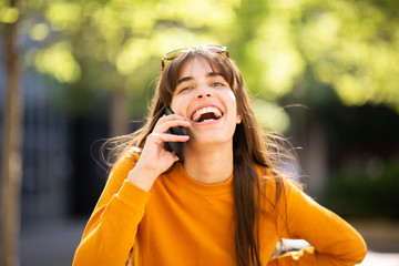 happy woman talking with cellphone in park