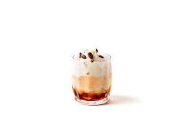 Cocktail with cream and coffee bean over white background