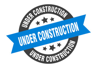under construction sign. under construction blue-black round ribbon sticker