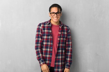 Fototapeta premium Man over grunge wall with glasses and happy