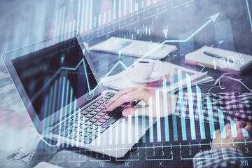 Double exposure of forex chart with man working on computer on background. Concept of market analysis.