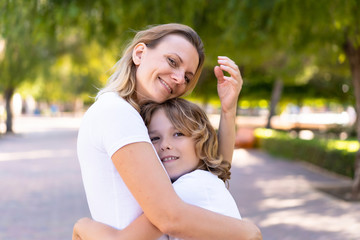 Mother and son in a park hugging and hugging