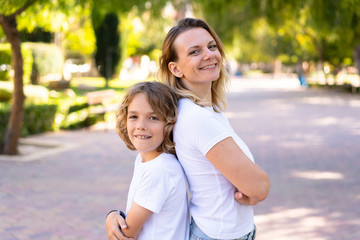 Naklejka premium Happy mother and son in a park