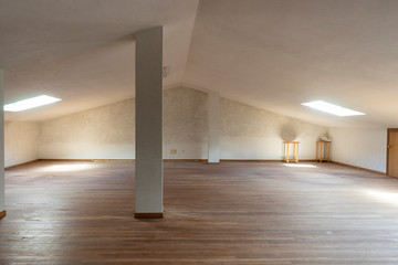 White and empty attic with wooden floor