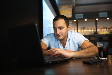 Armenian handsome man working behind laptop