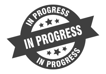 in progress sign. in progress black round ribbon sticker