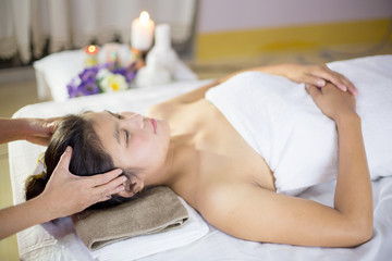 An Asian woman is massaging a herbal spa with a relaxing, happy feeling.