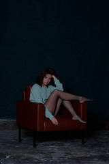 Obraz premium brunette sitting on a chair in a sweater
