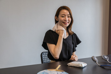 ハンズフリー扇風機を使う若い女性
