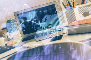 Financial market graph hologram and personal computer on background. Double exposure. Concept of forex.