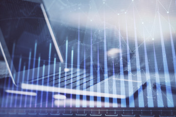 Forex market chart hologram and personal computer background. Double exposure. Concept of investment.