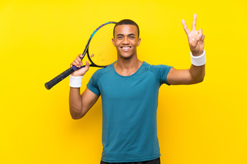 African American tennis player man smiling and showing victory sign