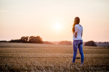 Frau auf dem Feld im Sonnenuntergang