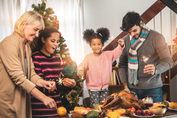 Thanksgiving Celebration Tradition Family Dinner Concept.family having holiday dinner and cutting turkey.Young black adult woman and her daughter happy..