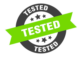 tested sign. tested black-green round ribbon sticker