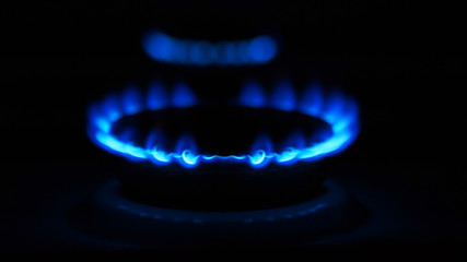 Gas stove with flames over it - on black background