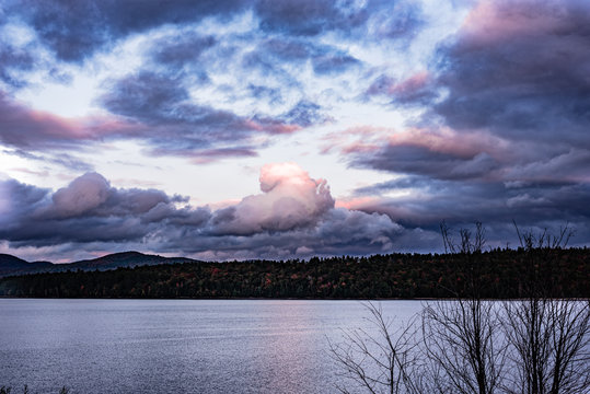 Lake and forest under cloudy skies