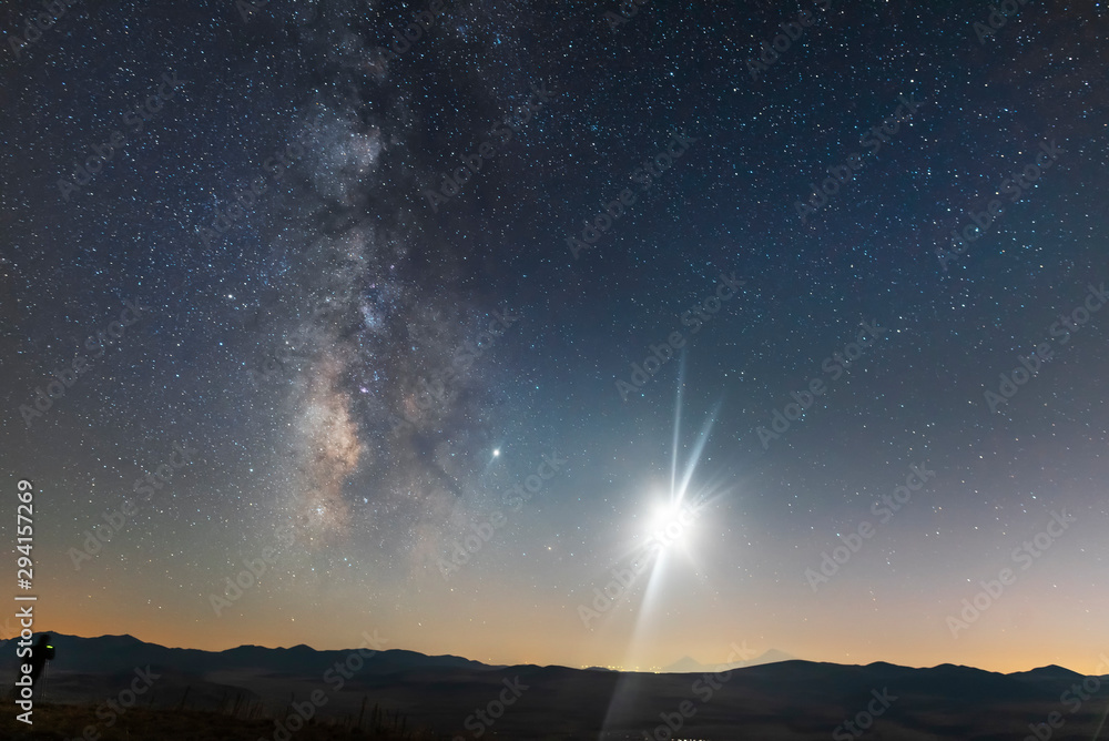 Wall mural beautiful milky way galaxy and moon over the hill. night landscape, astronomical background.