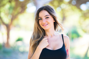 Portrait of young woman at outdoors in a park