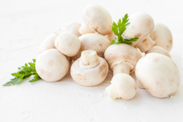 Champignon mushrooms with herbs on white background. 