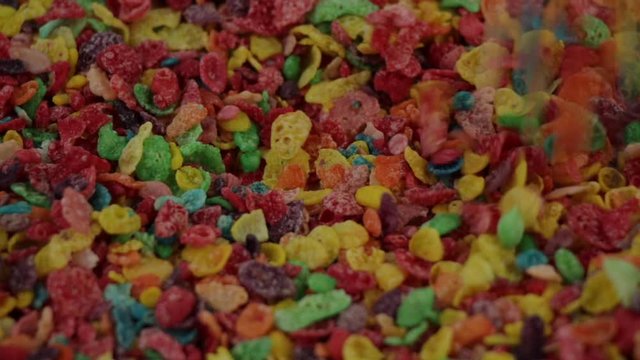 close up shot dropping fruity pebbles cereals, real time