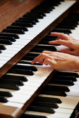 A woman playing the pipe organ 