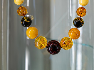 Amber neklace on a glass shelf