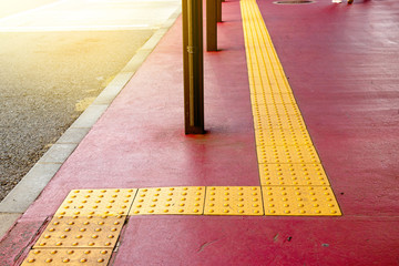 rough yellow dot tactile paving for blind handicap on tiles pathway in japan, walkway for blindness...