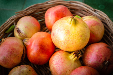 Close-up of pomegranates in a basket. Fresh fruit from Apulia region, Italy