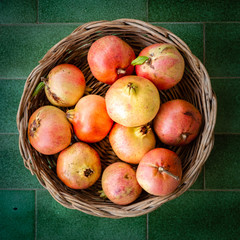 Basket full of pomegranates from Apulia region, Italy