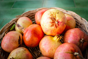 Close-up of pomegranates in a basket. Fresh fruit from Apulia region, Italy