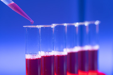 Test tube in rack and pipette media dispenser.