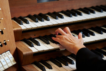 A woman playing the pipe organ 
