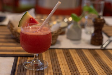 Cocktail served on a table with restaurant in the background