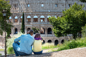 Father and dauther looking to Colloseum, Rome