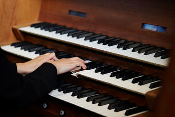 A woman playing the pipe organ 