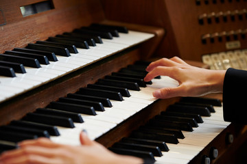 A woman playing the pipe organ 