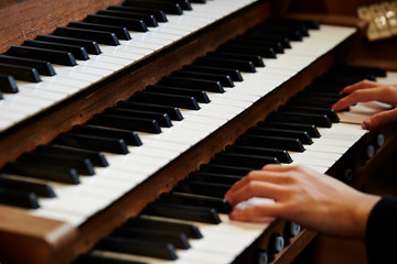 Fototapeta premium A woman playing the pipe organ 