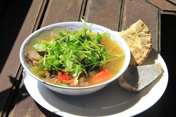 Traditional oxtail soup with vegetable, eat with breadfruit and yam.