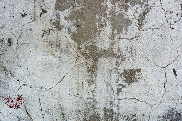 Texture of a concrete wall with cracks and scratches which can be used as a background