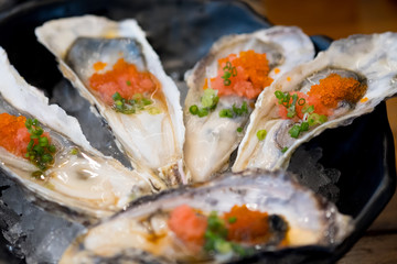 Big raw oyster with caviar on top look delicious