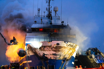Tromso, Norway 25.09.2019 A Russian fishing trawler named "Bukhta Nayezdnik" which caught fire in Norway on Wednesday has overturned and is mostly 