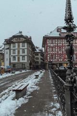The old town of Lucerne with the roofs of the buildings covered with snow, after a snowfall on a...