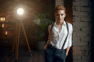 Business woman in strict clothes at the window