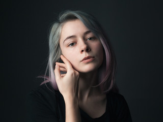 Portrait of adorable young woman with blue and violet hair. Studio.