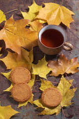Tea, cookies and autumn leaves